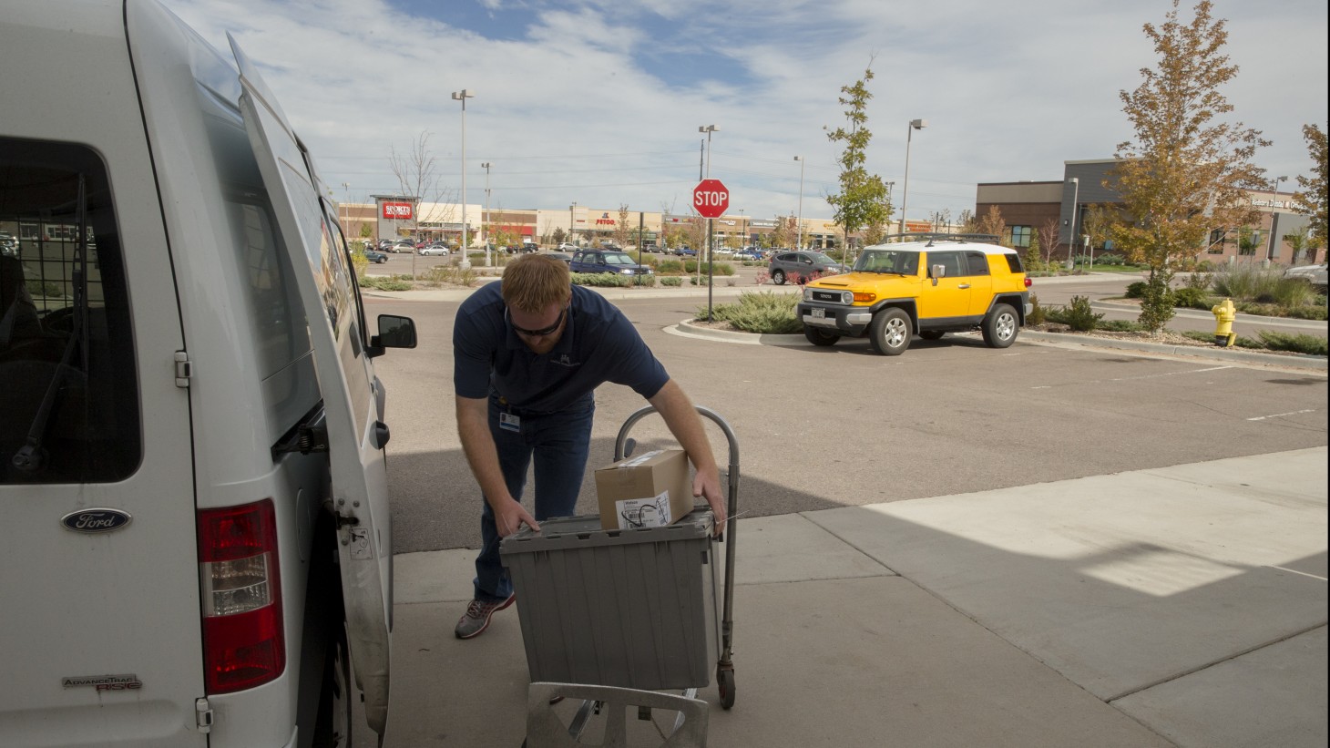 alt="Drivers help load vans."