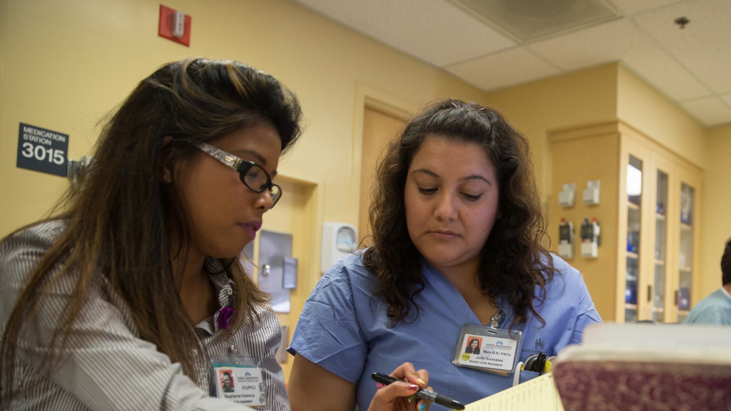 Staff members go over discharge paperwork