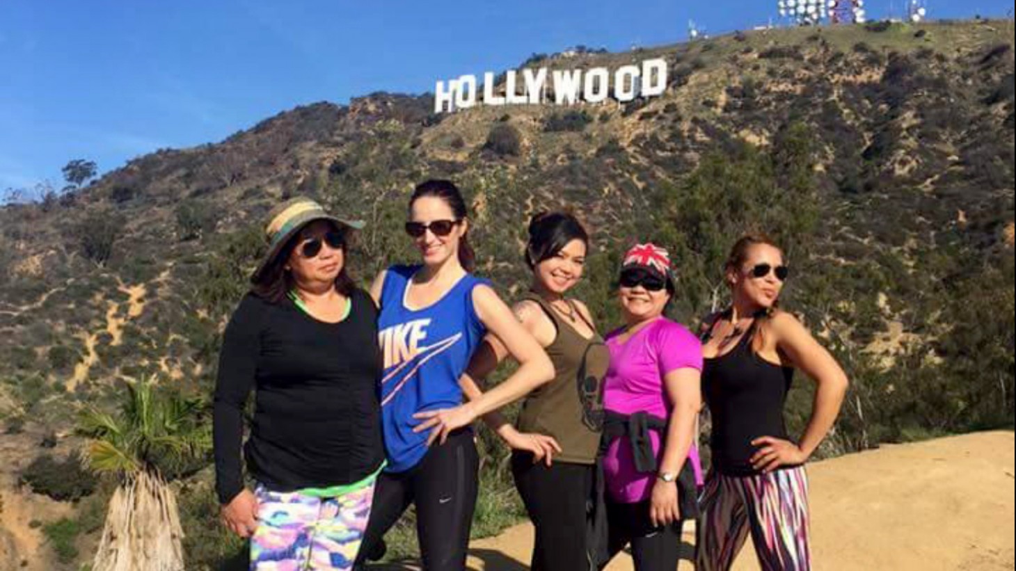 Team members pose with the Hollywood sign