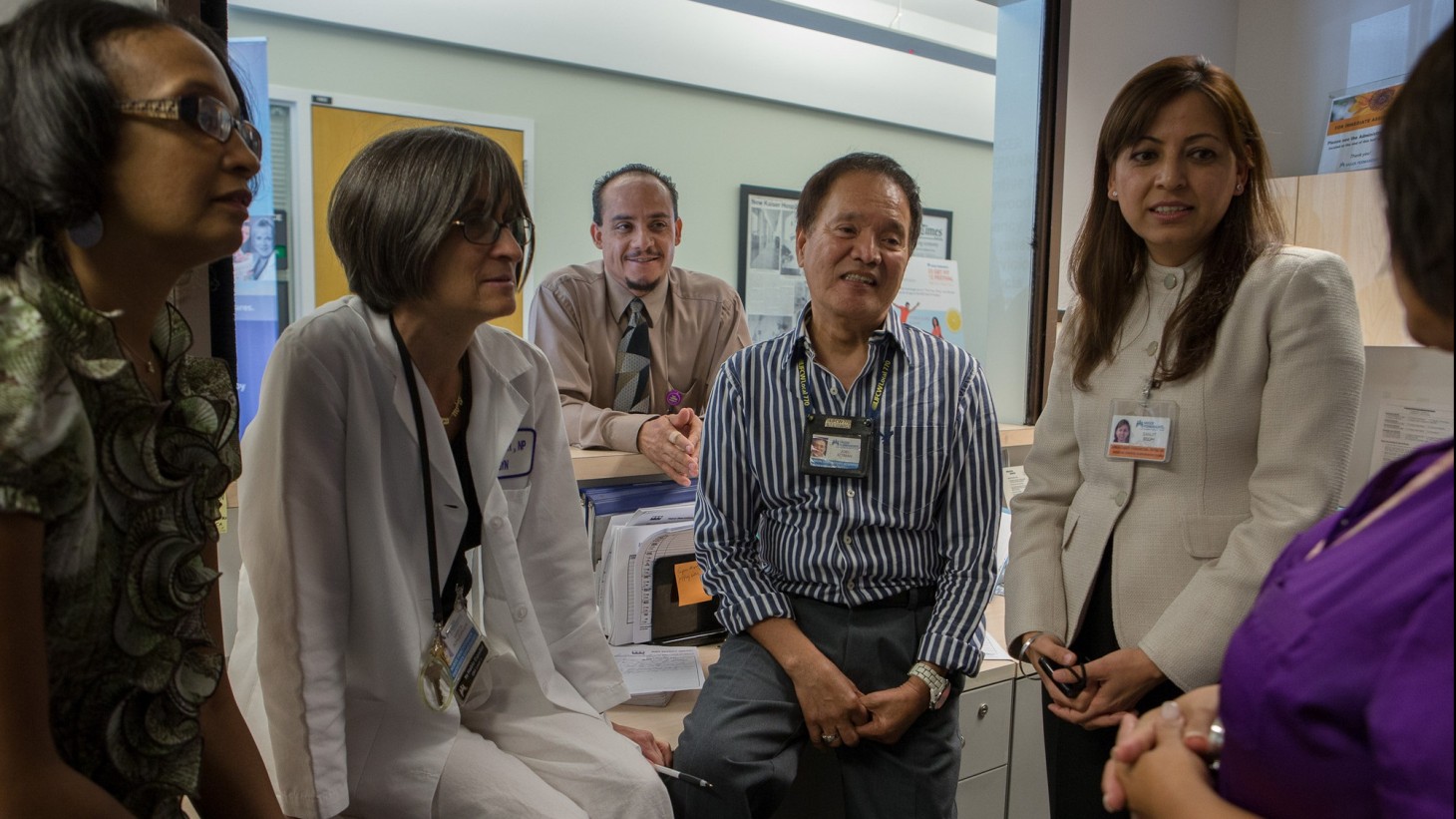 Several health care workers standing in a casual huddle