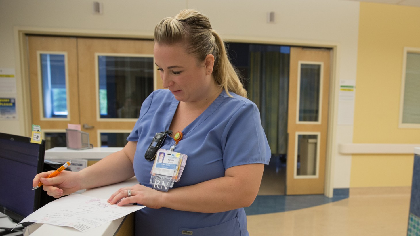 Nurse filling out paperwork.