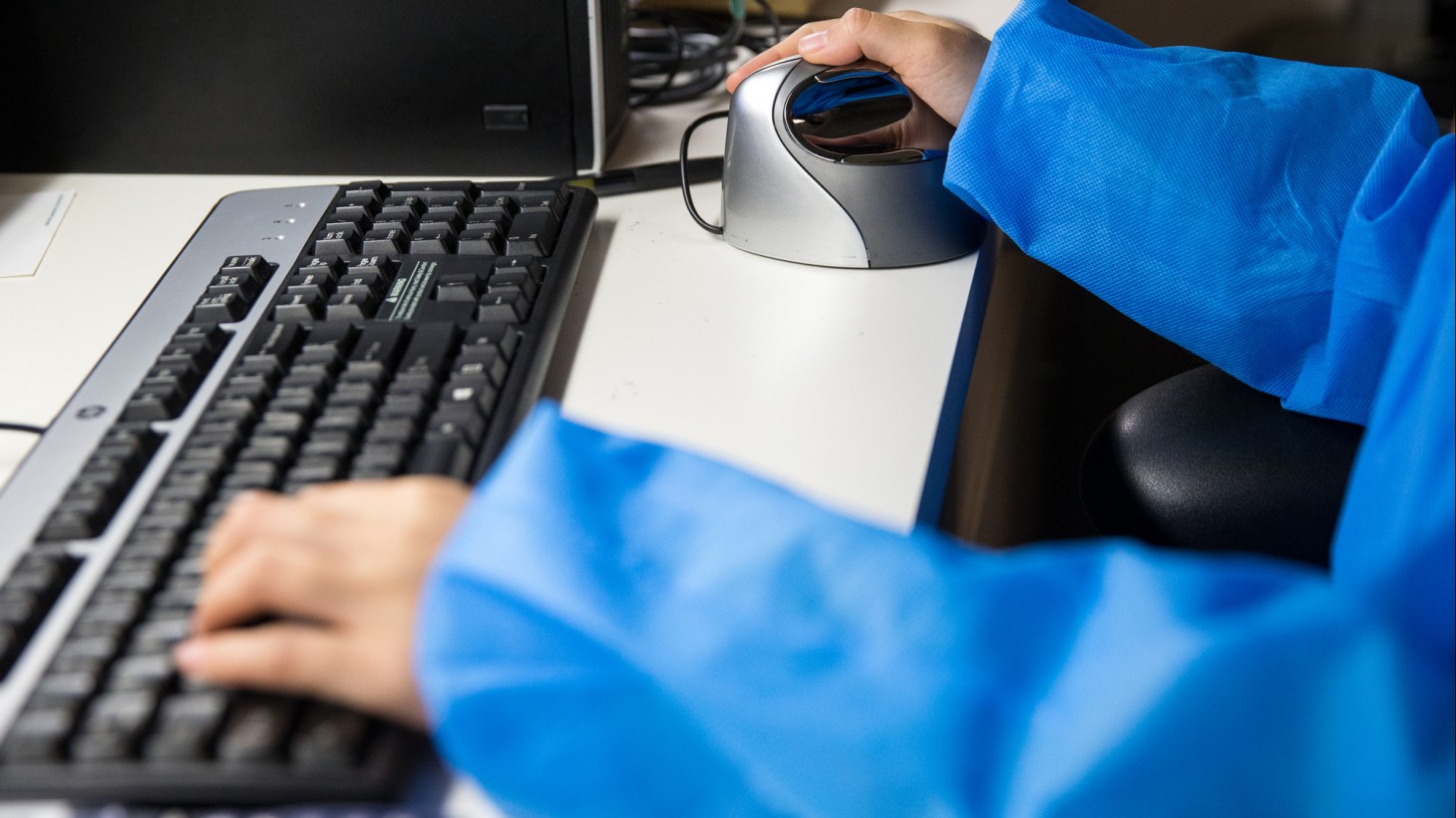 hands on a computer keyboard and mouse