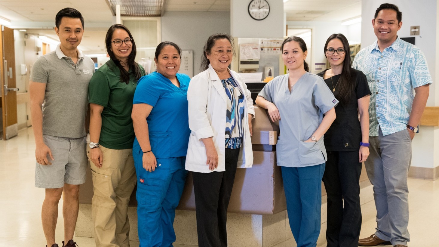 group of health care workers posing at a hospital nurses' station