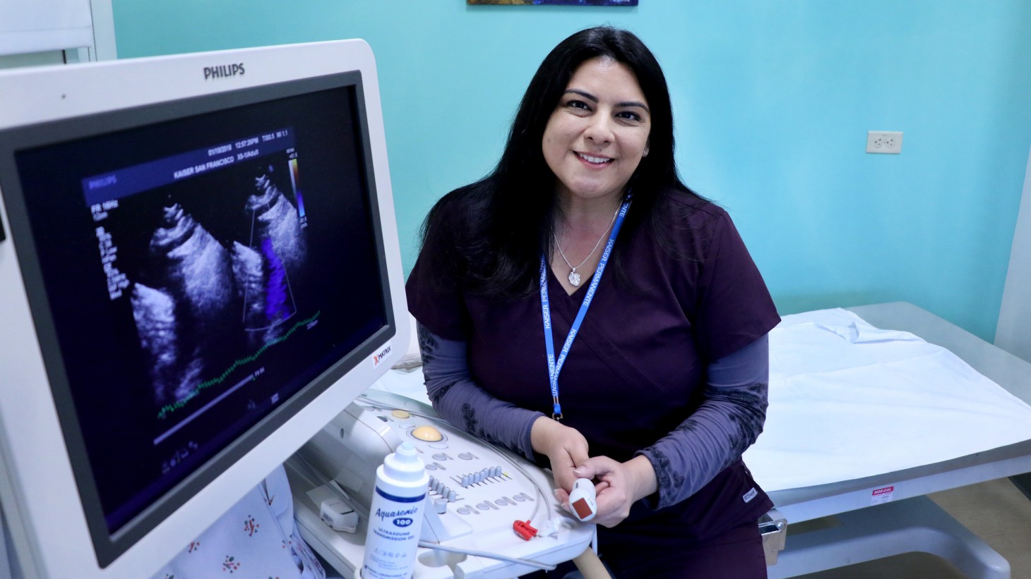 Portrait of sonographer sitting next to her equipment 