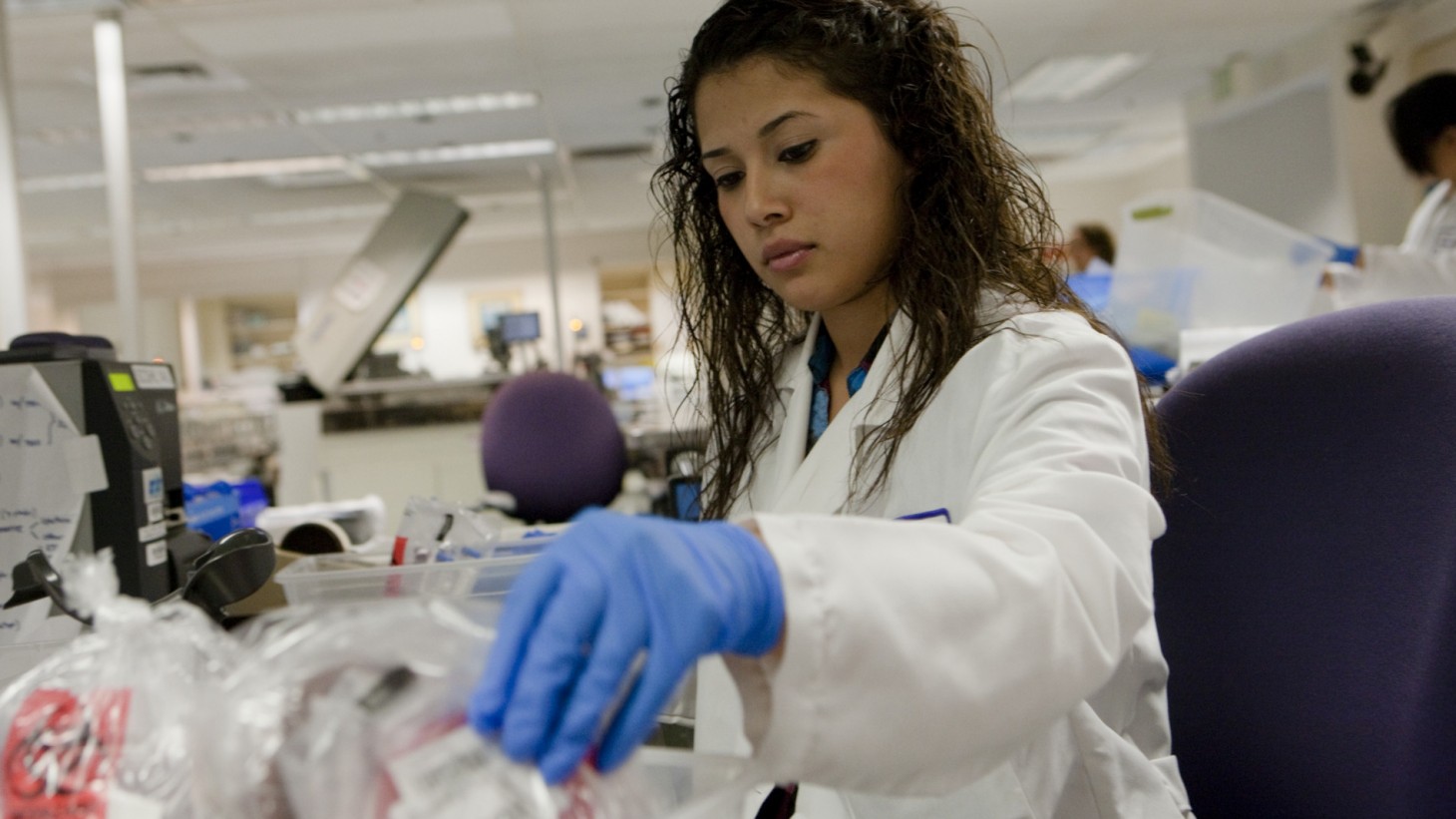 Female tech handling specimen bags.